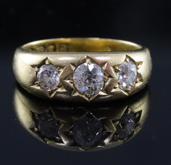 A late Victorian 18ct gold and gypsy set three stone diamond ring, size N/O.